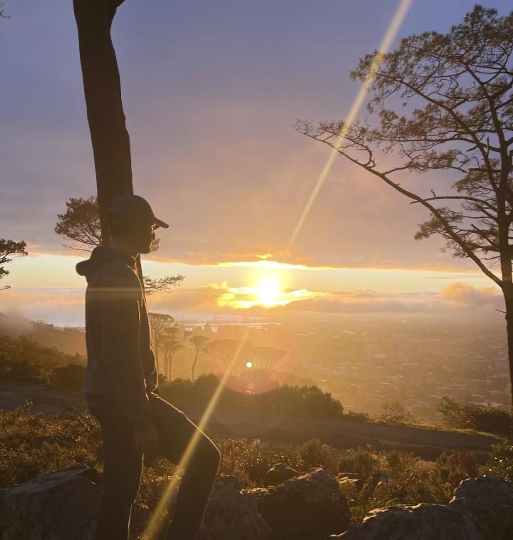 Student looking out at sunrise from Signal Hill South Africa